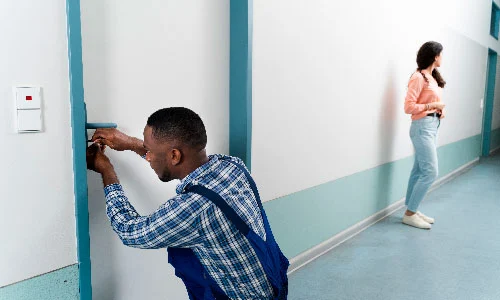 Technician helping a woman get back into her apartment