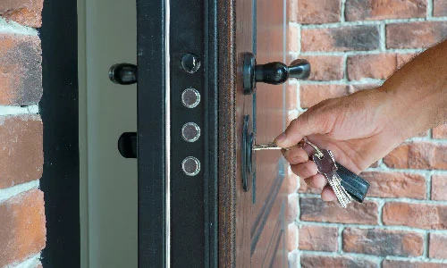 Hand inserting a key into a lock