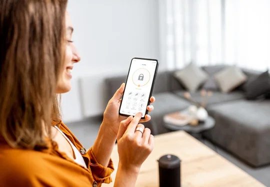 A smiling woman uses an app on her smartphone