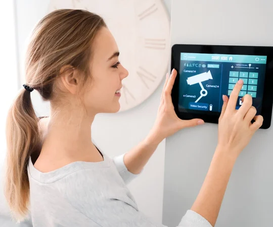 A woman enters a passcode into an access control keypad