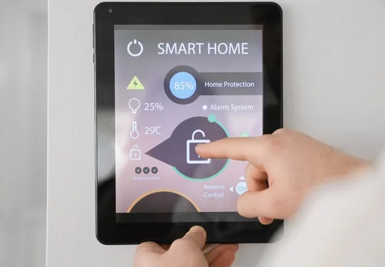 A hand interacts with a smart home app on a tablet