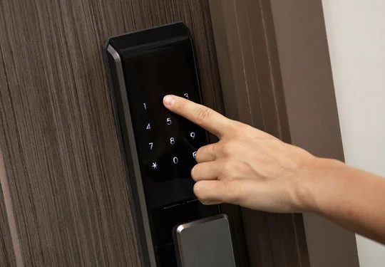 A hand presses keys on a keypad