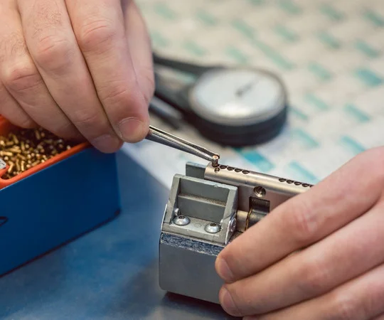 Hands working on a lock mechanism