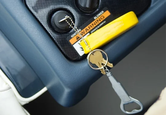 A key sits in a boat ignition