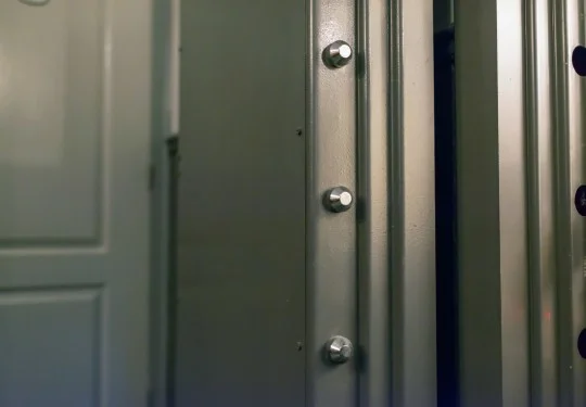 A residential vault door being installed