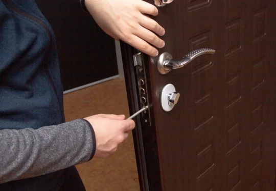 A technician changes a door lock