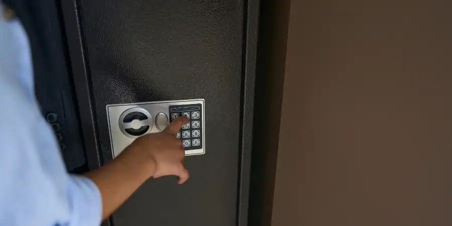 A teen works the combination of a gun safe